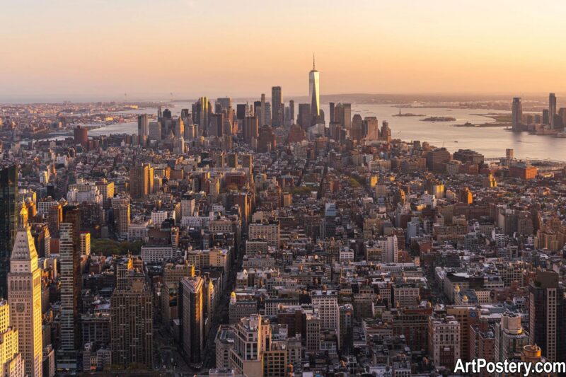 Poster New York showing an aerial skyline view of Manhattan at sunset with warm golden light and the river in the background
