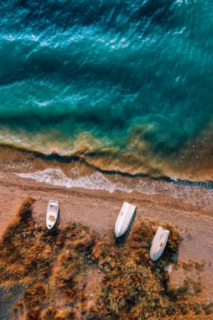 Three Boats on Rocky Shoreline Photographic Print 90